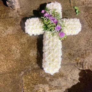 Elegant funeral cross wreath with fresh white flowers for funeral tributes in Nairobi.