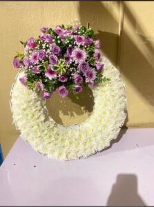 Round funeral wreath made with fresh flowers for memorial and funeral services in Nairobi.